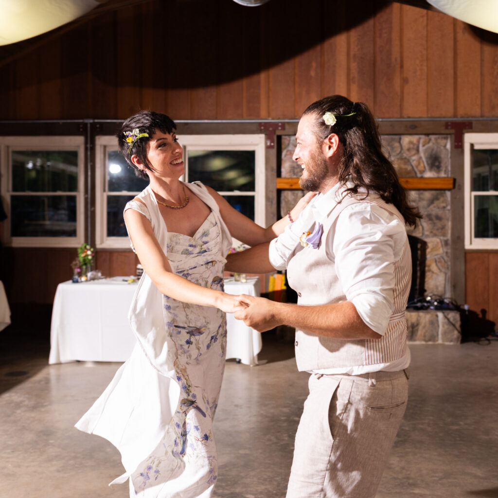Framed by the rustic wooden lodge and golden light, Dennis and Samantha dance closely, smiling as they lock eyes. This tender moment capped off a day filled with adventure, love, and laughter, bringing their Cloudland Canyon wedding to a perfect close.
